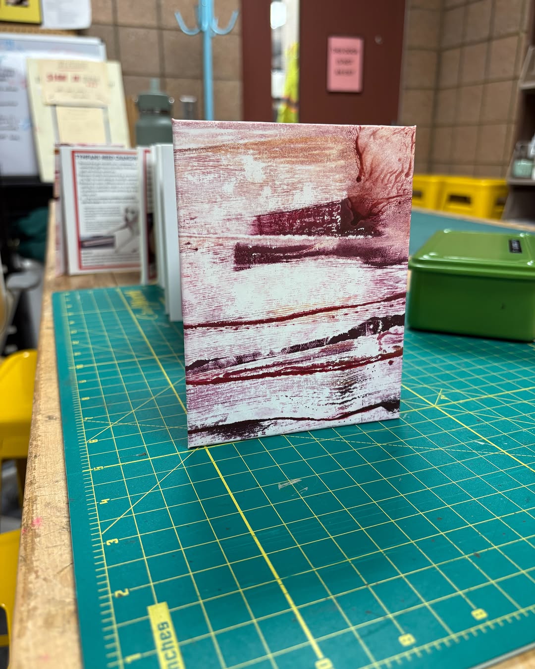 Photo of Tanner Schudlich of Stout Heart Press's hand binding of the tympan zine